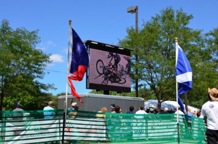 Bike crash seen on large screen monitor at bike race