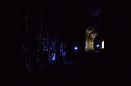 Bike Riders with helmet lights in tunnel