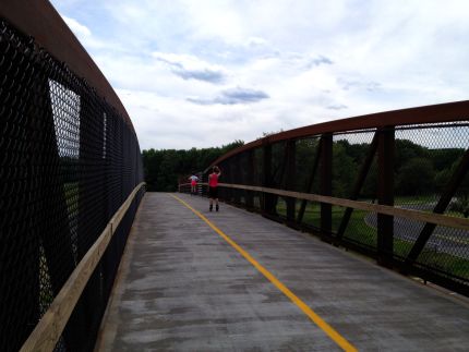 Roller Bladers on bridge over Higgins