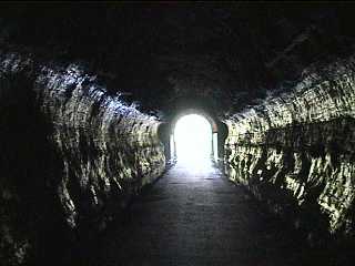 Light reflecting off rock walls looking out from tunnel #1